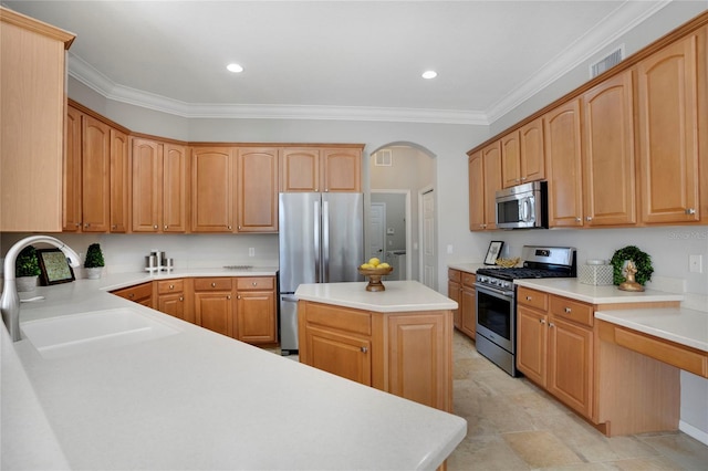 kitchen with sink, ornamental molding, stainless steel appliances, and a kitchen island