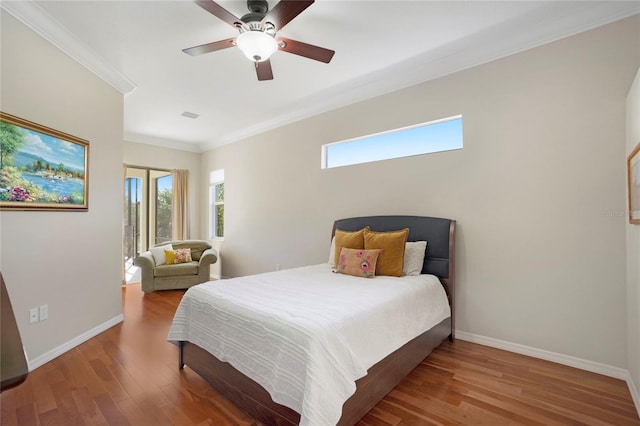 bedroom featuring ornamental molding, hardwood / wood-style floors, and ceiling fan