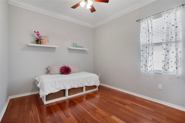 bedroom featuring crown molding, wood-type flooring, and ceiling fan