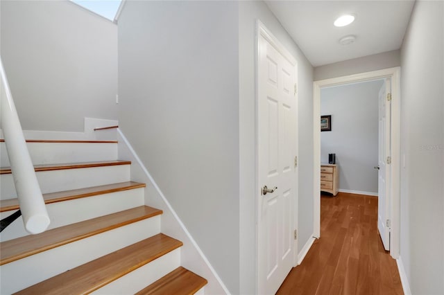 staircase featuring wood-type flooring