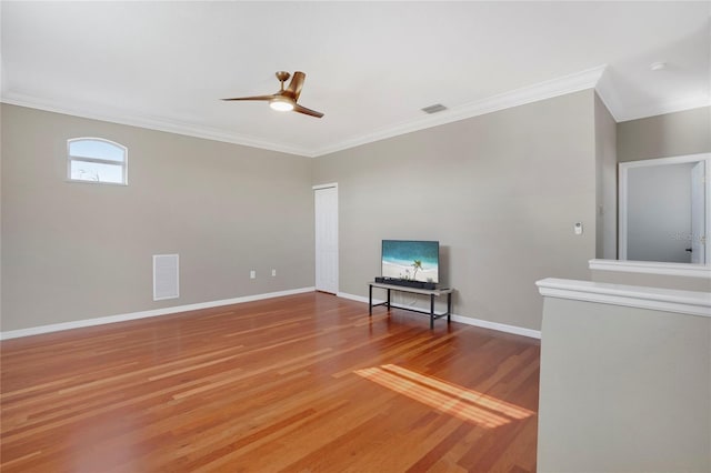 unfurnished room with ornamental molding, hardwood / wood-style floors, and ceiling fan