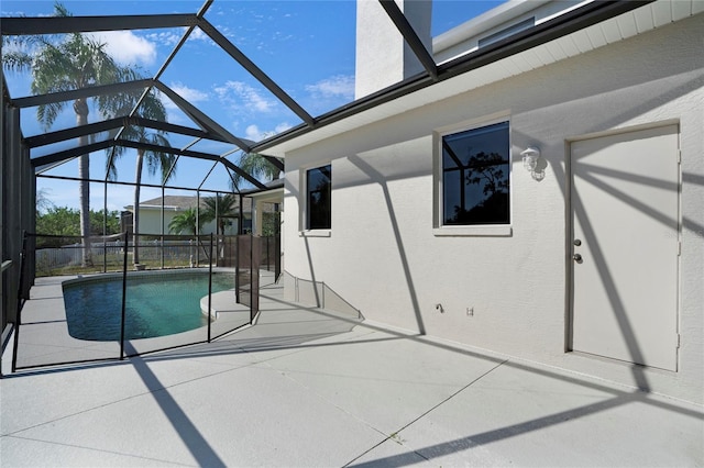 view of swimming pool featuring a lanai and a patio area