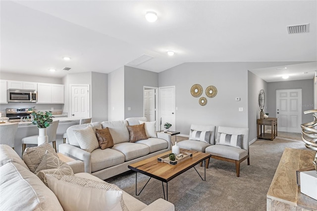 living area featuring visible vents, vaulted ceiling, light carpet, and baseboards