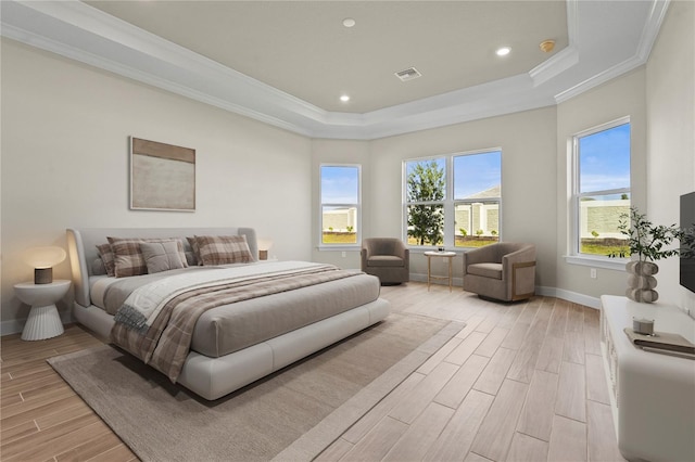 bedroom featuring wood tiled floor, baseboards, crown molding, and a tray ceiling