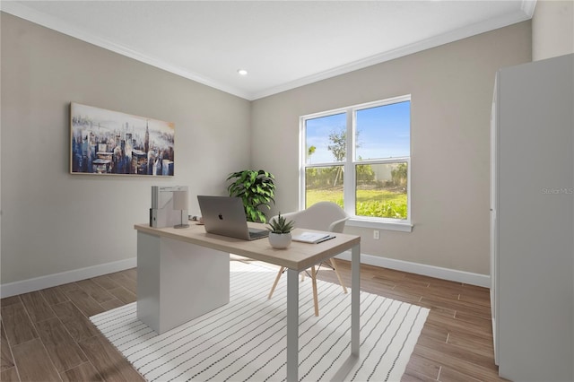 office area with crown molding, baseboards, and wood finished floors