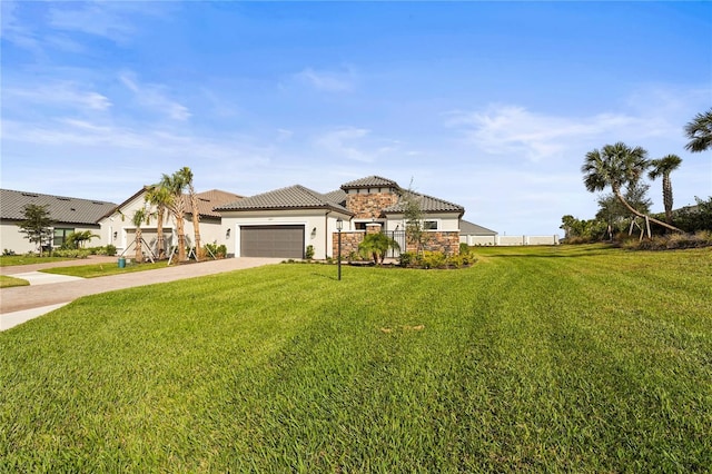 mediterranean / spanish home with a garage, driveway, a front lawn, and a tiled roof