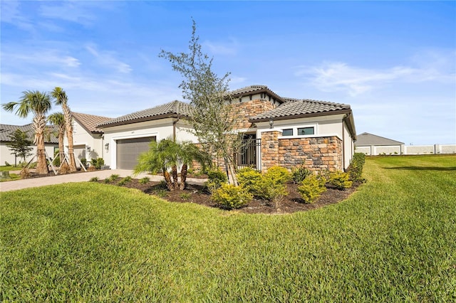 mediterranean / spanish-style house featuring a garage, a front yard, concrete driveway, and a tile roof