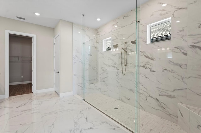 full bathroom featuring recessed lighting, baseboards, marble finish floor, a spacious closet, and a marble finish shower