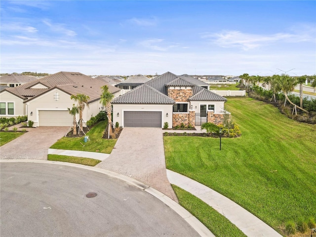 view of front of house featuring stone siding, a tile roof, a residential view, a front yard, and stucco siding