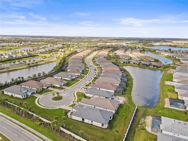 drone / aerial view featuring a water view and a residential view