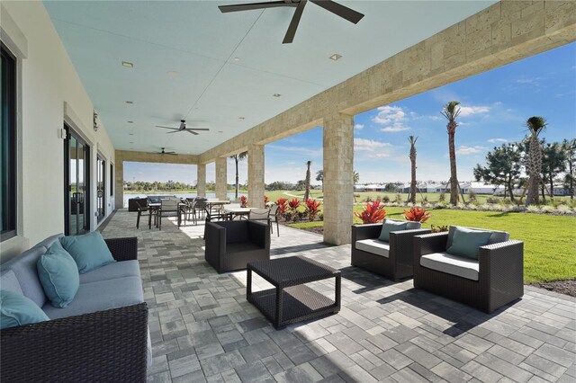 view of patio / terrace featuring outdoor dining space, outdoor lounge area, and ceiling fan