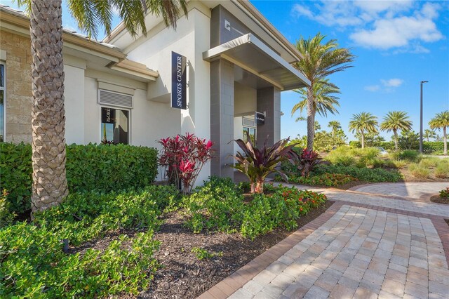 doorway to property featuring stucco siding