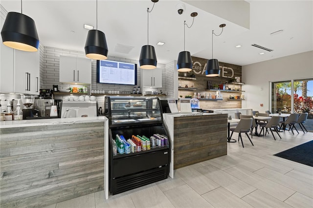 kitchen with white cabinetry, open shelves, tasteful backsplash, modern cabinets, and decorative light fixtures