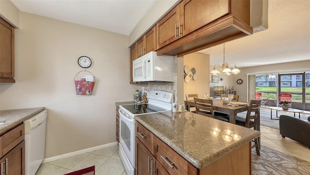 kitchen with stone countertops, pendant lighting, a chandelier, light tile patterned floors, and white appliances