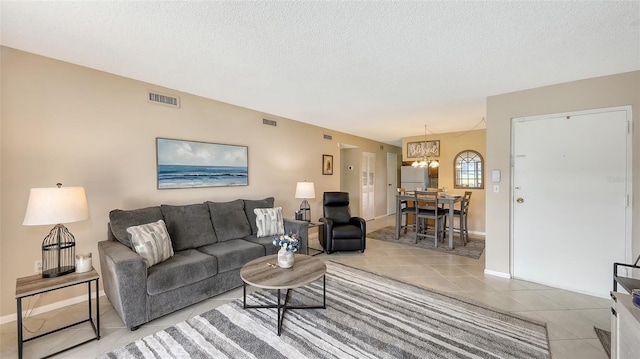 living room featuring light tile patterned flooring and a textured ceiling