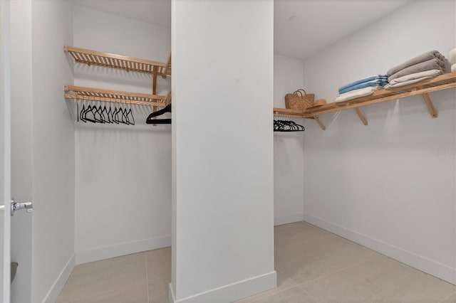 spacious closet with light tile patterned flooring