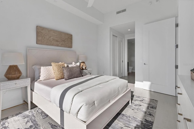 bedroom with wood-type flooring and a closet