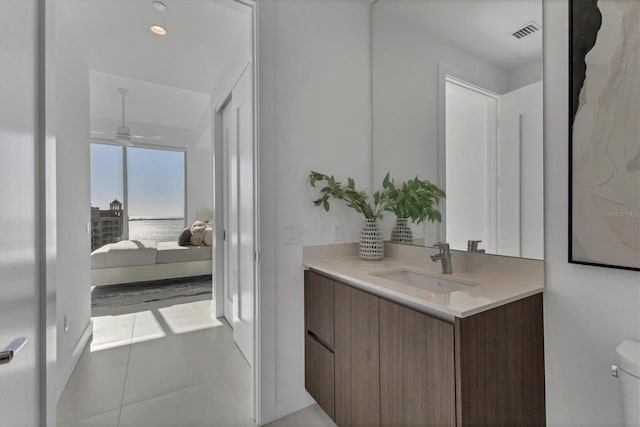 bathroom with vanity, tile patterned floors, ceiling fan, and toilet