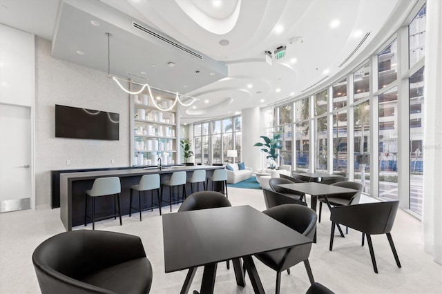 dining room featuring wet bar and a wall of windows