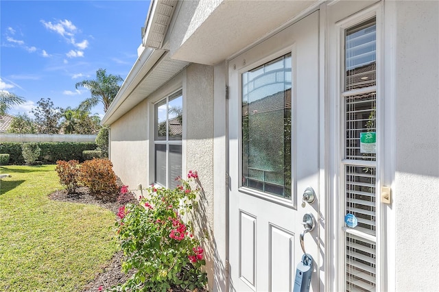 doorway to property featuring a yard