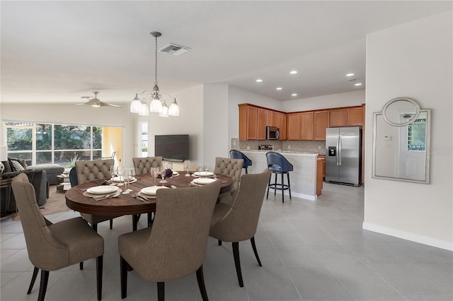 dining room with lofted ceiling, light tile patterned floors, and ceiling fan