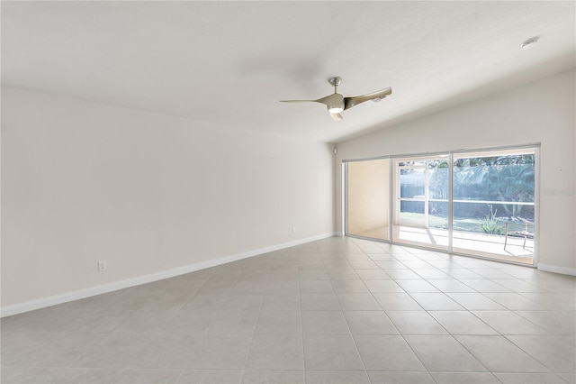 unfurnished room featuring lofted ceiling, ceiling fan, and light tile patterned flooring