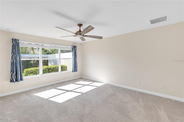 carpeted spare room with ceiling fan