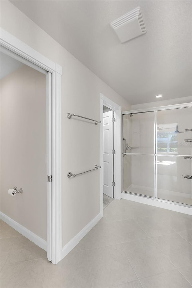 bathroom featuring walk in shower and tile patterned floors