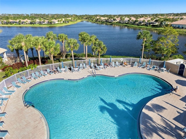 view of pool featuring a water view and a patio