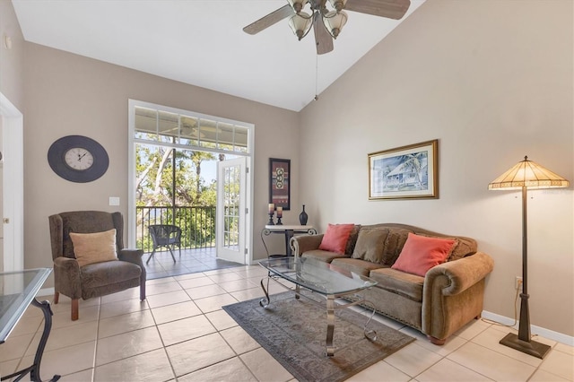 tiled living area featuring high vaulted ceiling, baseboards, and a ceiling fan