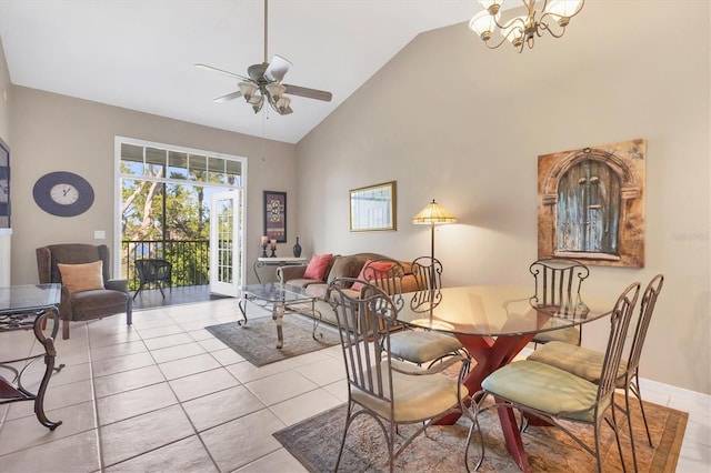 dining area with high vaulted ceiling, tile patterned flooring, and ceiling fan with notable chandelier