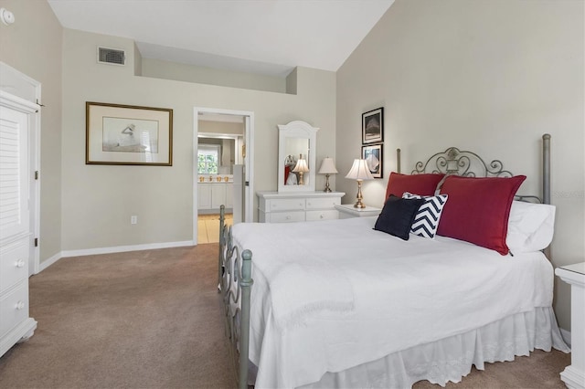 bedroom with visible vents, connected bathroom, baseboards, vaulted ceiling, and carpet flooring