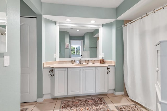 full bathroom featuring baseboards, vanity, and tile patterned flooring