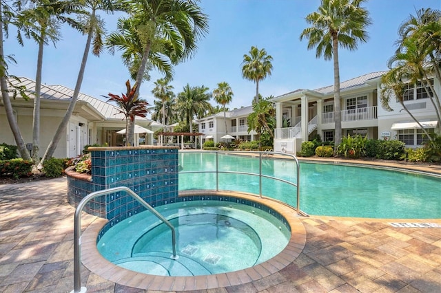 pool featuring a residential view and a community hot tub