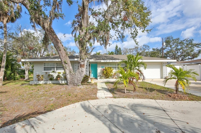 view of front of property featuring a garage, driveway, and stucco siding