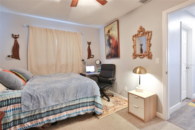 bedroom featuring light carpet, ceiling fan, and baseboards