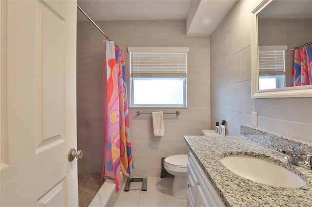 full bath featuring toilet, vanity, a shower stall, and tile walls