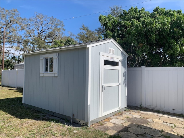 view of shed with a fenced backyard