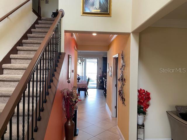 interior space featuring crown molding and light tile patterned floors