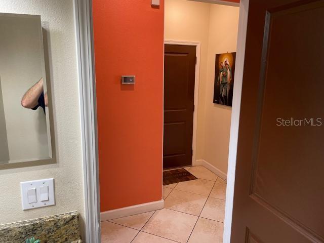 corridor with light tile patterned floors