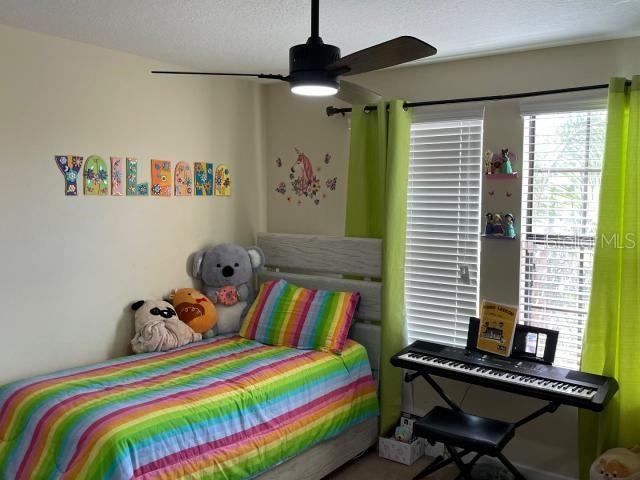 bedroom with a textured ceiling and ceiling fan