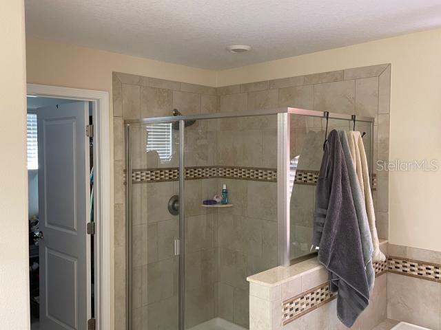 bathroom with a shower with door