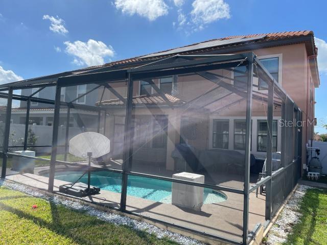 rear view of house featuring a patio and a lanai