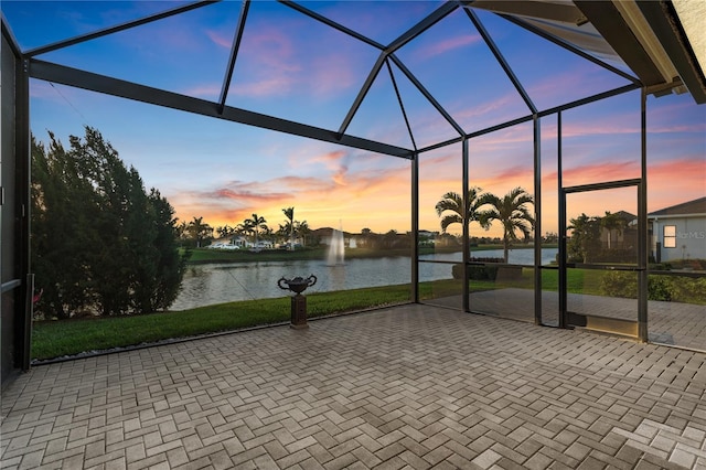 5074 Surfside Cir, Bradenton, FL 34211 - patio terrace at dusk featuring a water view, glass enclosure, and a patio area