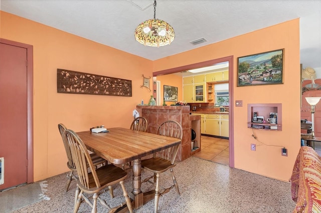 dining room featuring sink and a textured ceiling