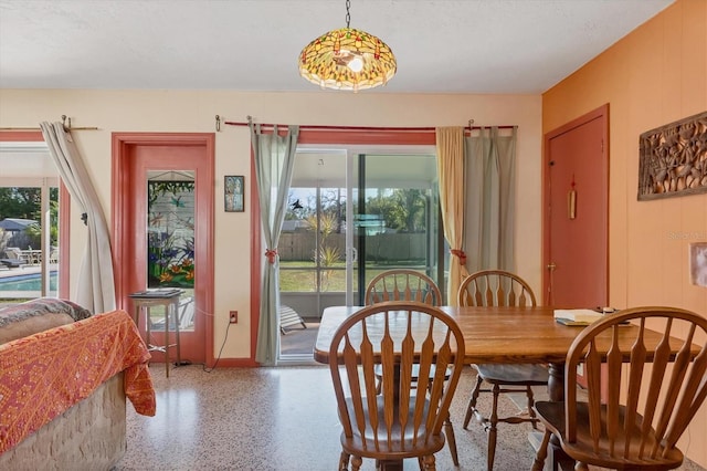 dining space featuring a textured ceiling