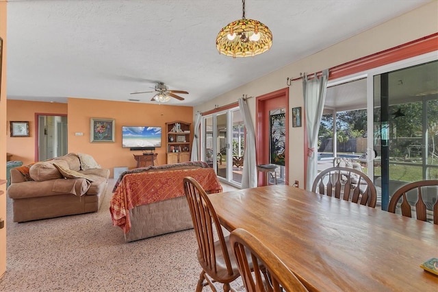 dining room featuring ceiling fan and a textured ceiling