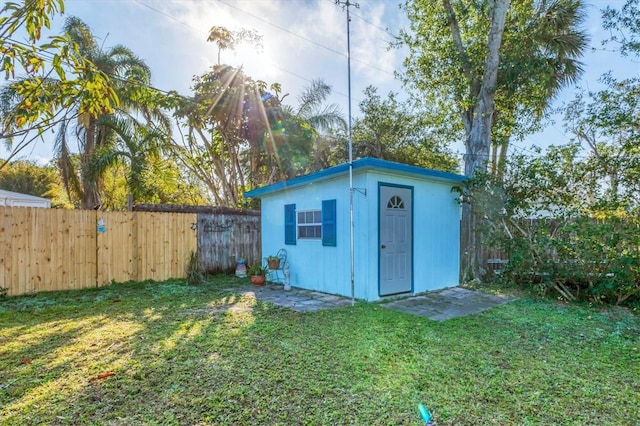 view of outbuilding featuring a lawn