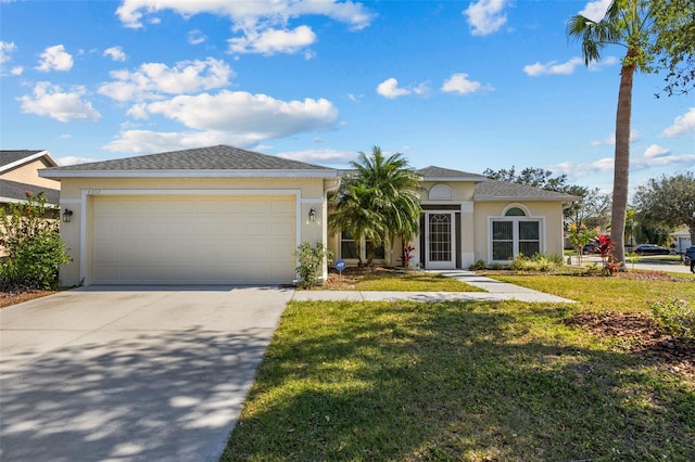 view of front of property featuring a front lawn, concrete driveway, an attached garage, and stucco siding