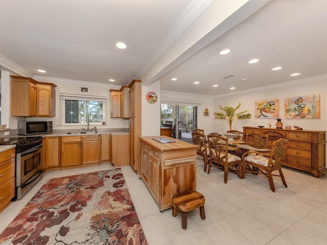 kitchen featuring crown molding, light countertops, a sink, and stainless steel range with electric cooktop